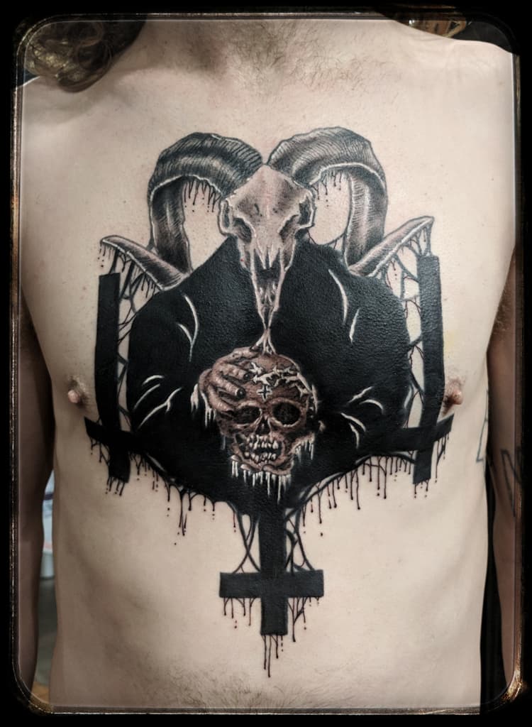Ram skull over a black-robed figure holding a skull, with inverted crosses and drips, black and grey chest piece